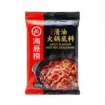 Haidilao Spicy Flavour Hot Pot Soup Base package on pure white background - red and black foil packaging with golden text and hot pot imagery